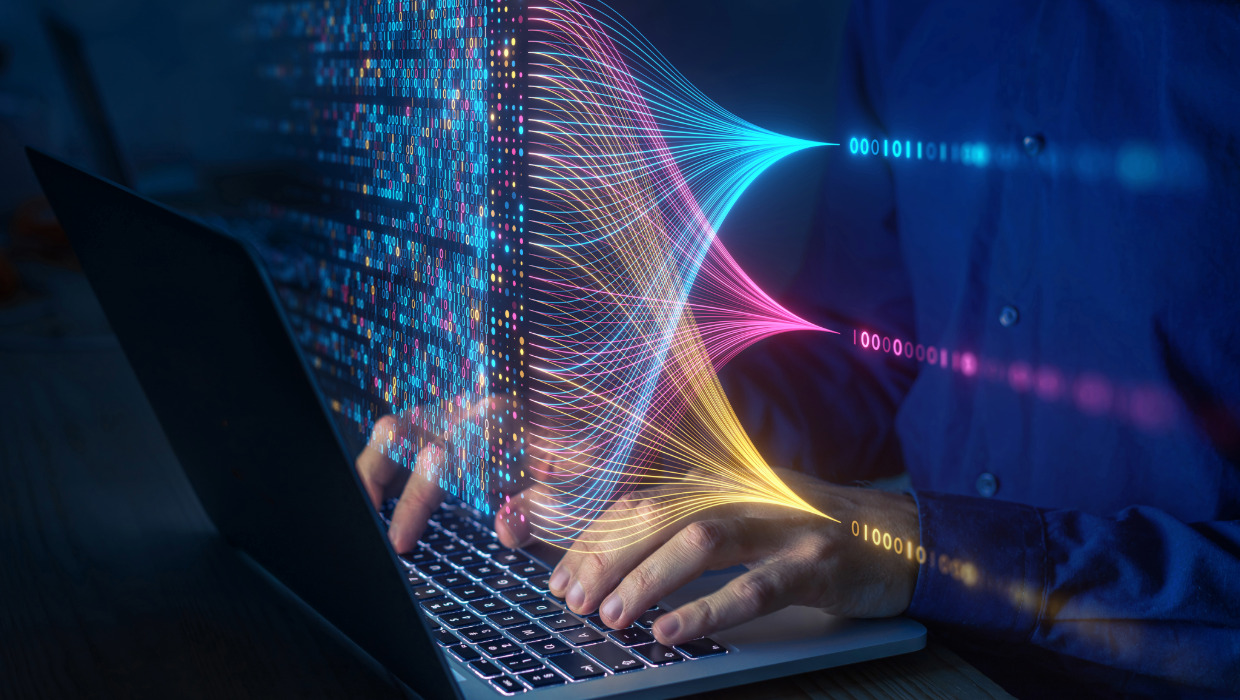 Hands on laptop overlaid with abstract connections